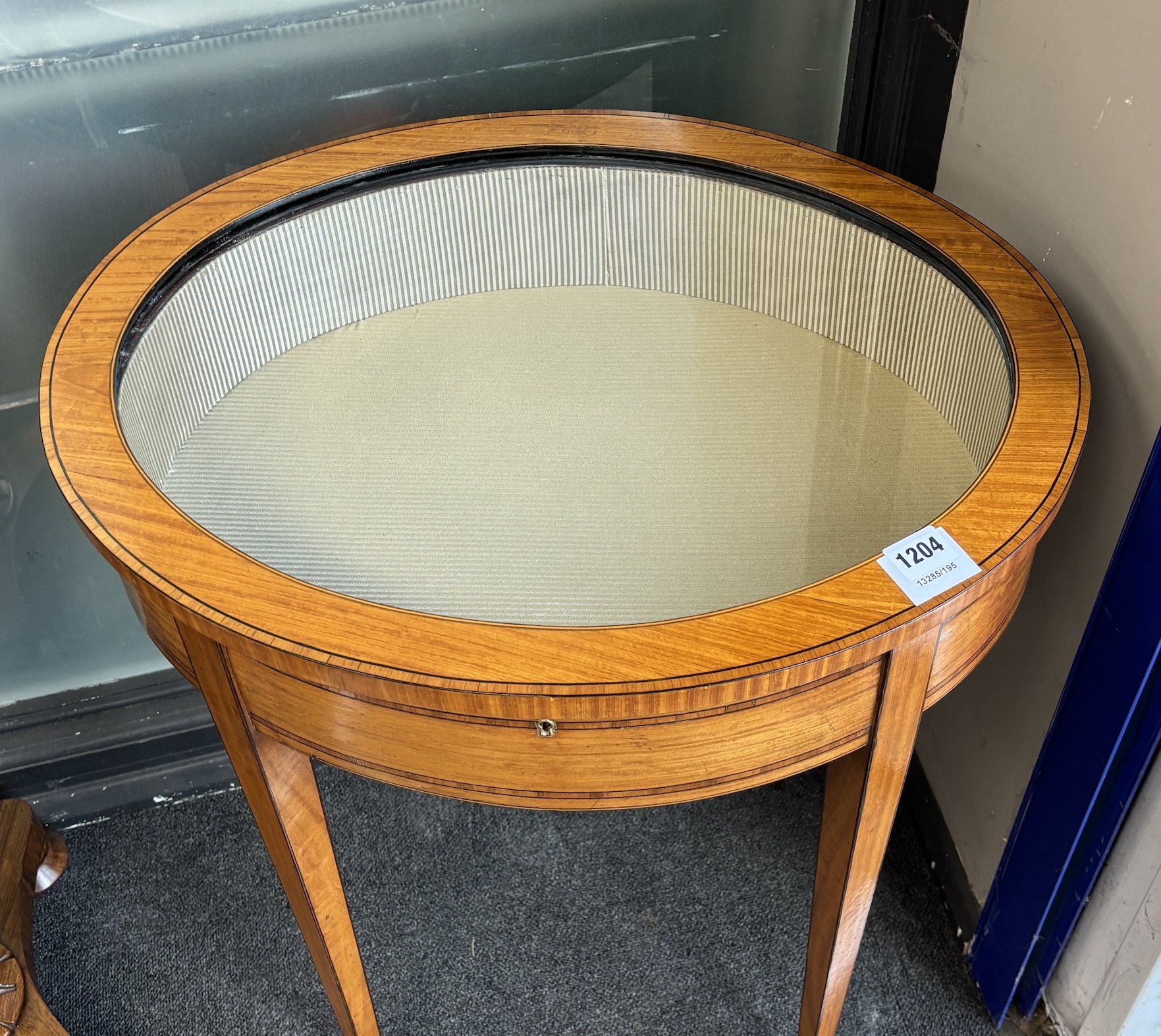 A Sheraton style satinwood oval bijouterie table, width 57cm, depth 45cm, height 70cm